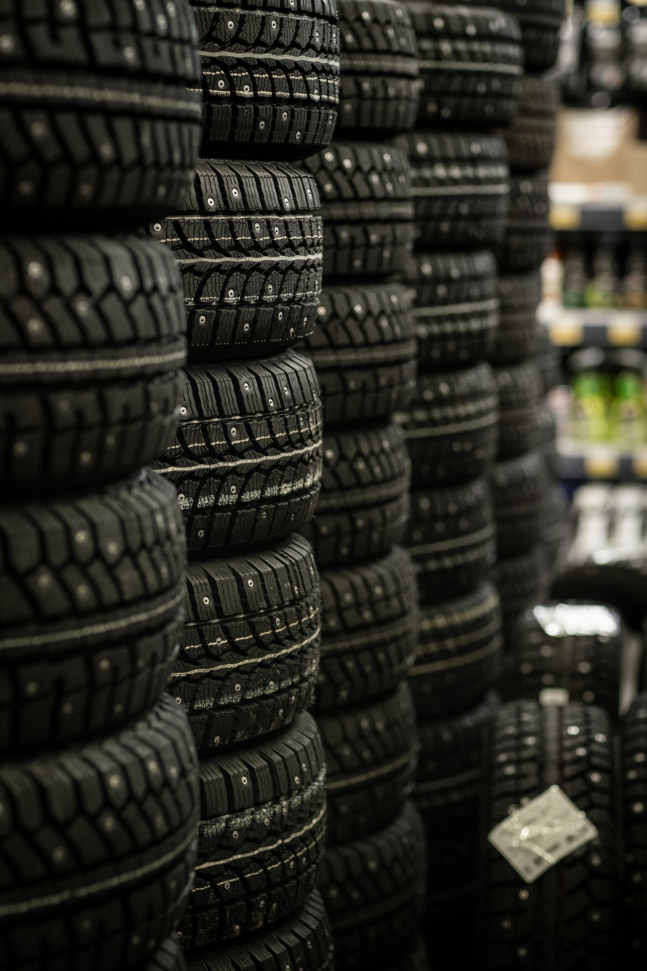 Sale of car tires for sale in the store. Many new winter tires lie